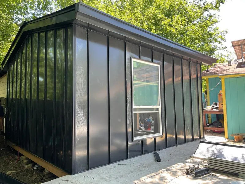 Black standing seam metal wall panels for Roof Inspection in Harvest